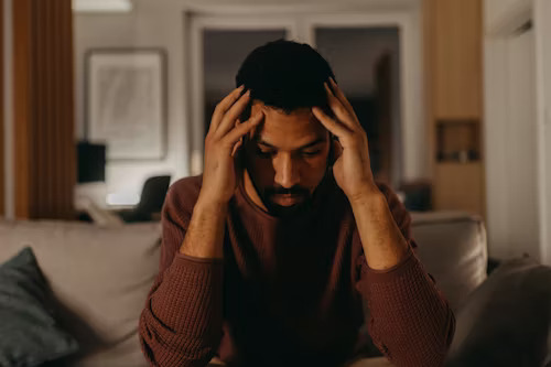 man holding his head in stress